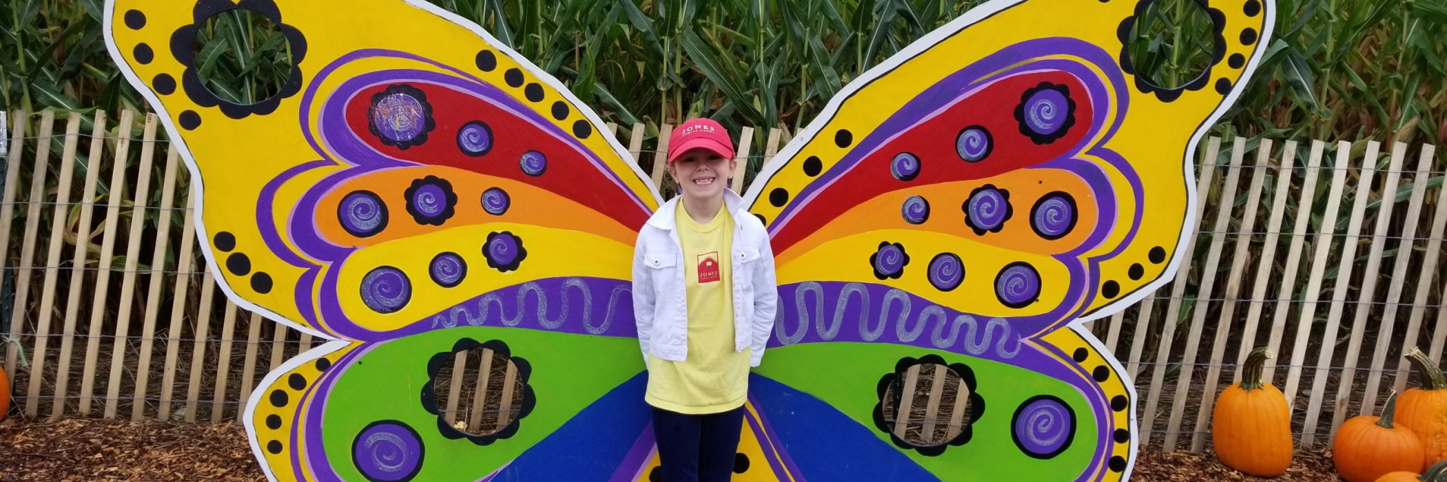 Child at the center of a colorful butterfly photo op